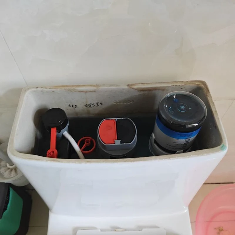 How does an automatic toilet cleaning dispenser reduce chemical exposure compared to sprays